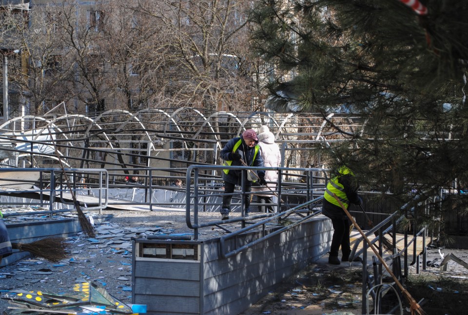 Cleanup crews remove debris from a damaged structure in Odesa, Ukraine, following a drone strike.