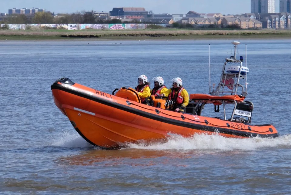 RNLI lifeboat crew searching the Thames River.