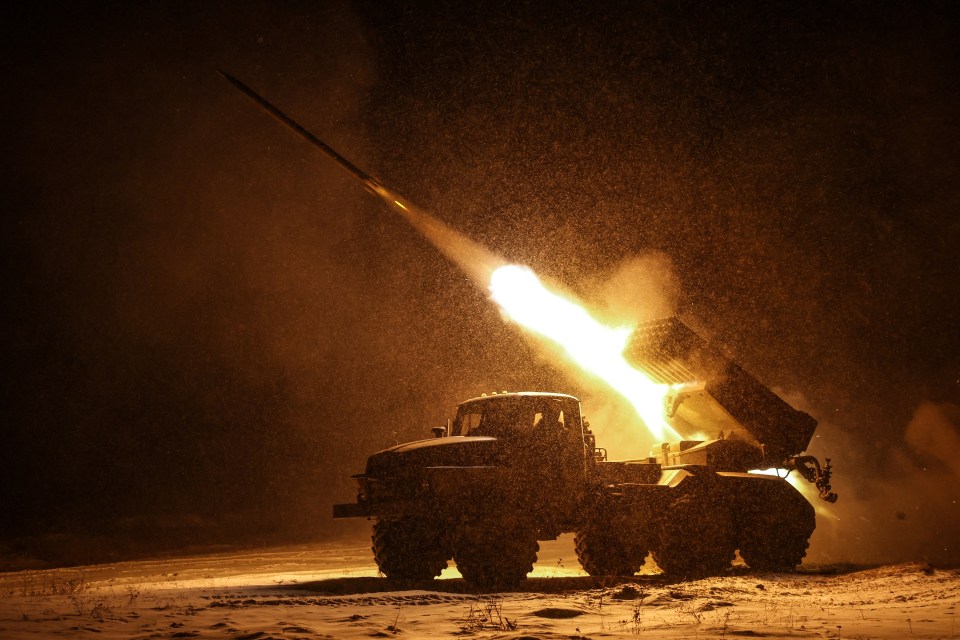 Ukrainian servicemen firing a BM-21 Grad multiple rocket launcher at night.