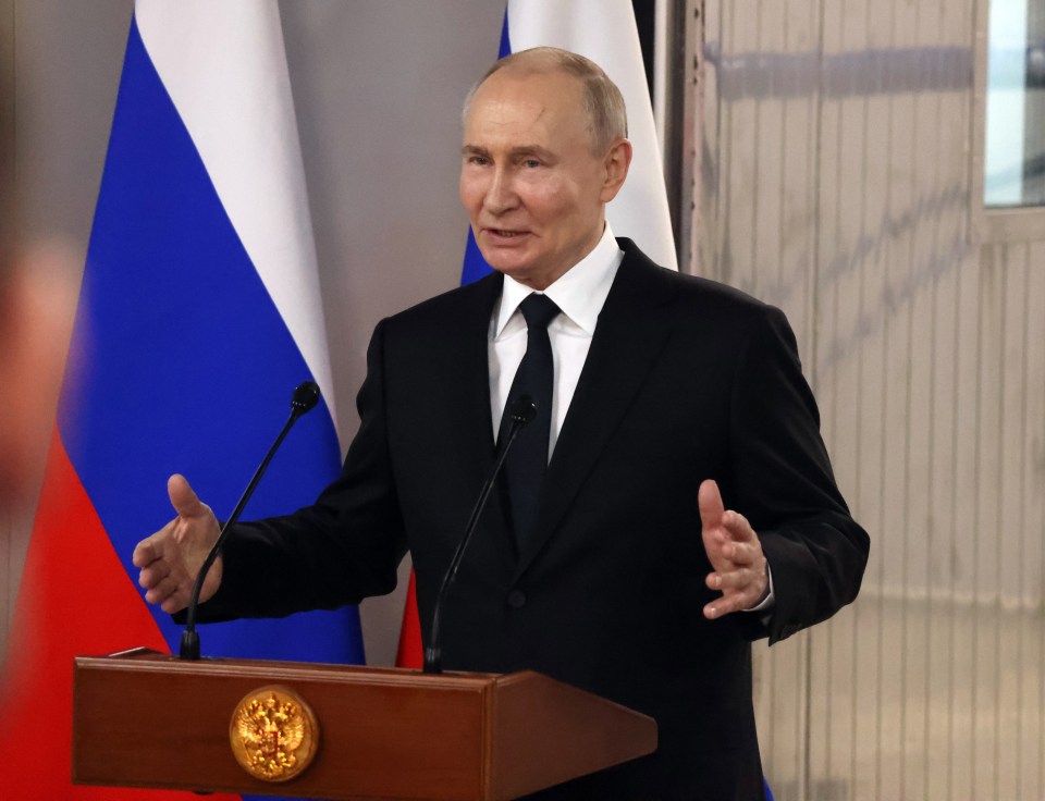 Vladimir Putin speaking at a podium.