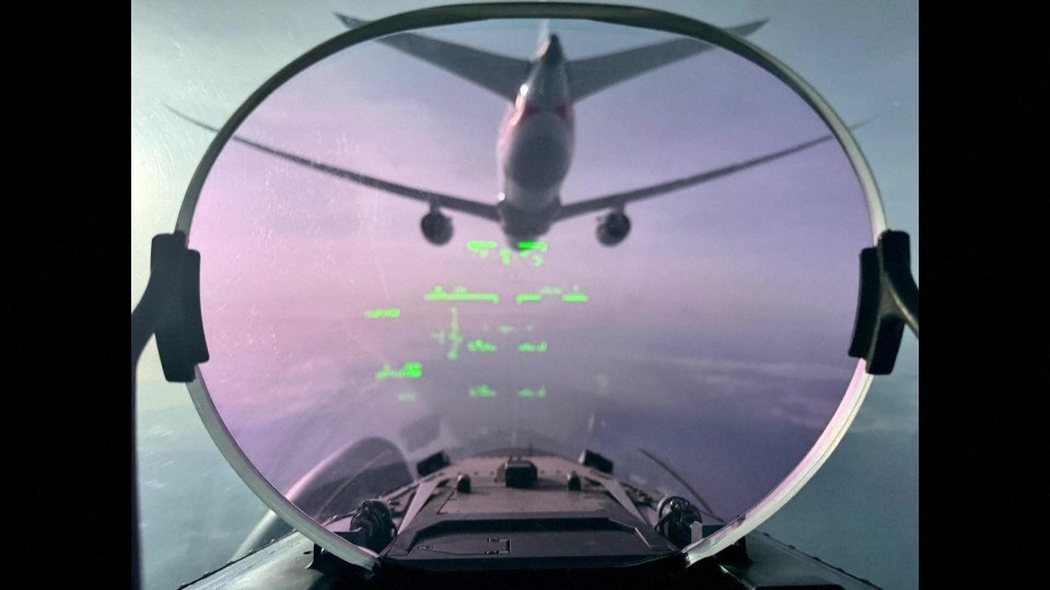 View from a fighter jet cockpit of an American Airlines plane being escorted.