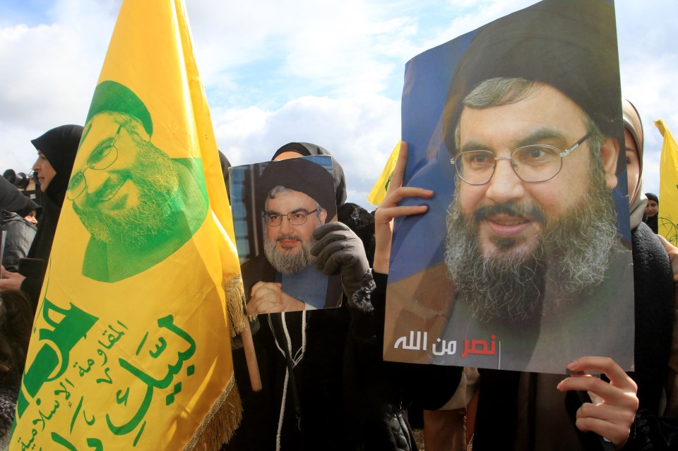 Protesters in Lebanon hold portraits of Hassan Nasrallah during a demonstration.
