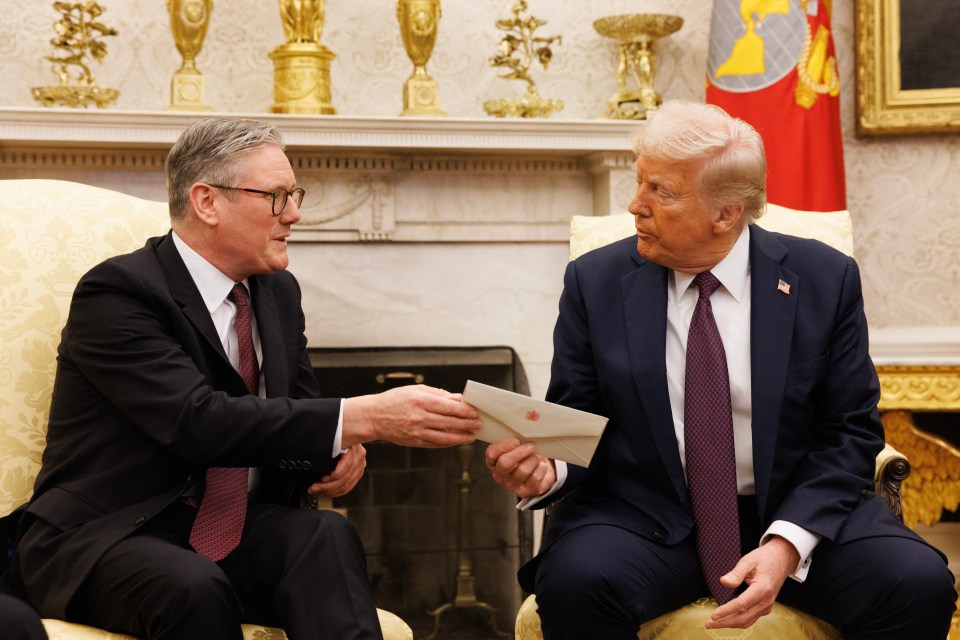 Keir Starmer handing Donald Trump an envelope during a meeting at the White House.
