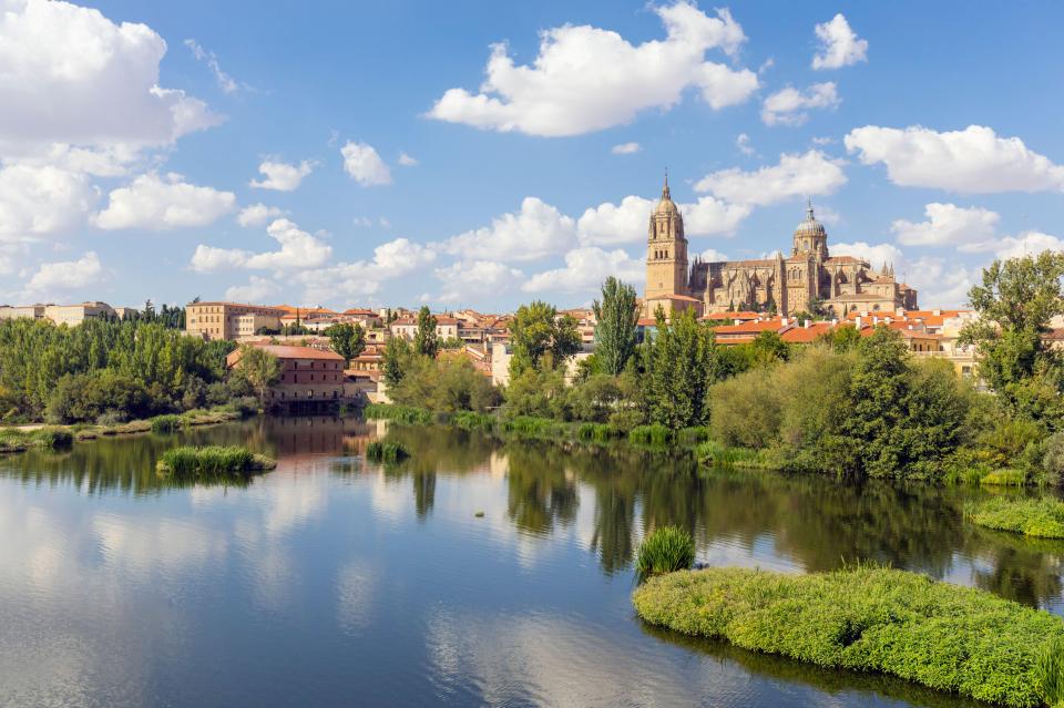 Cathedral Nueva in Salamanca, Spain, reflected in the Tormes River.