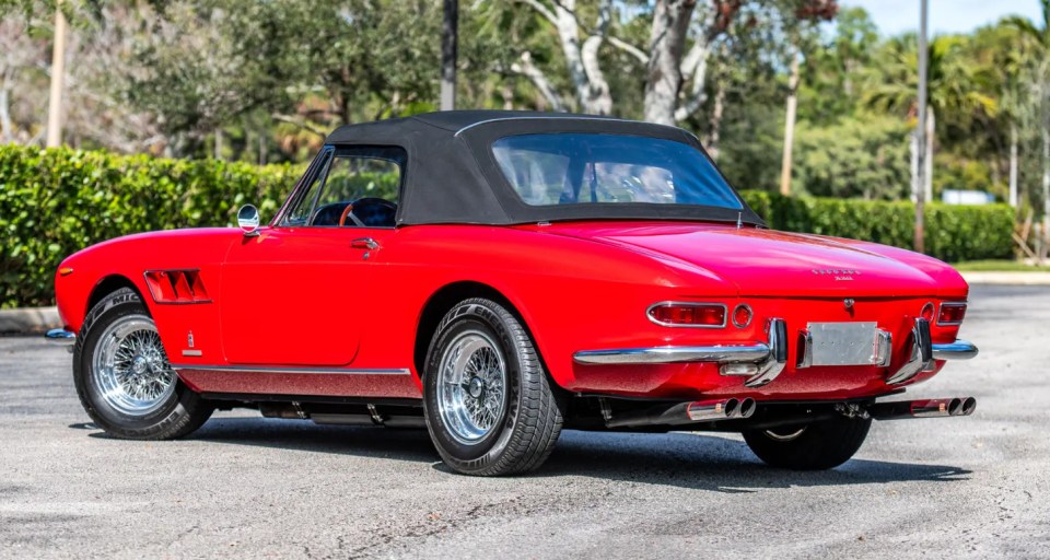 Rear view of a red 1966 Ferrari 330 GTS convertible.