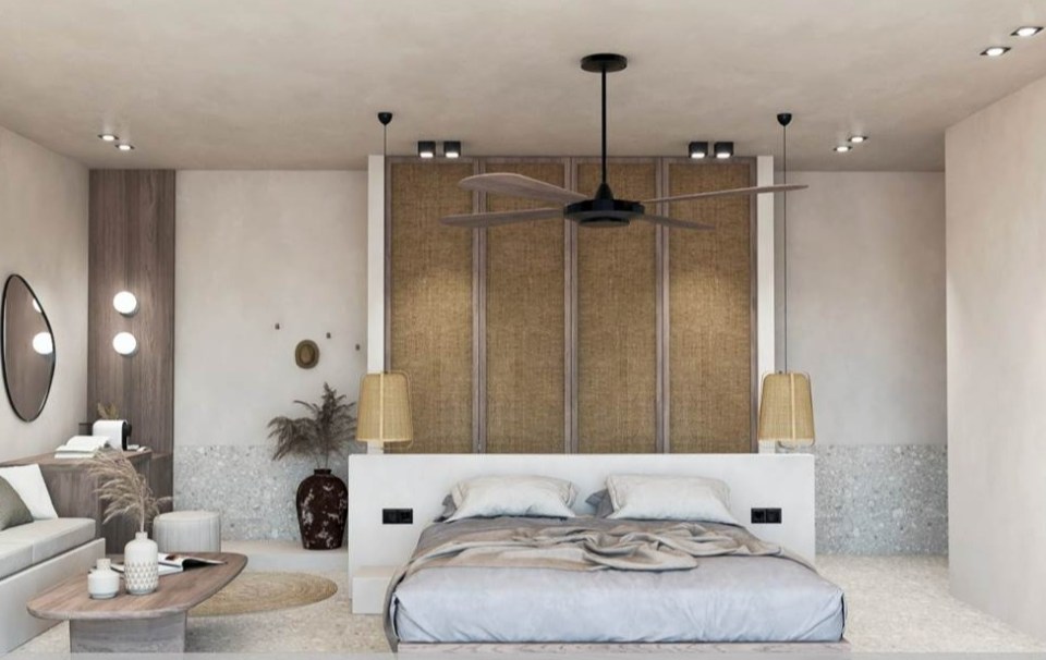 Artist impression of a hotel room with a bed, seating area, and ceiling fan.