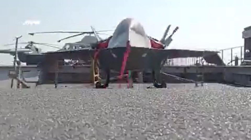 Drone carrier warship with mini-fighter jets and helicopters.