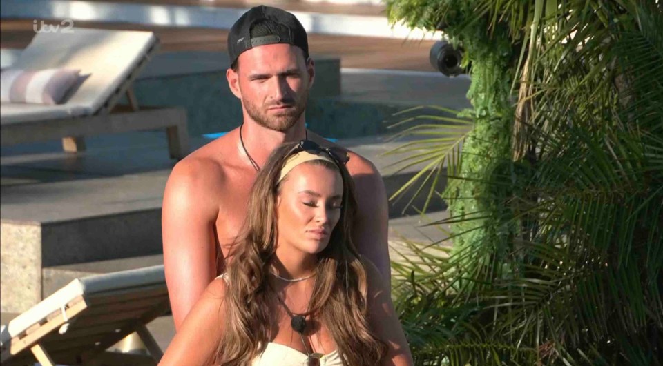 Screenshot of a couple sitting together outdoors.