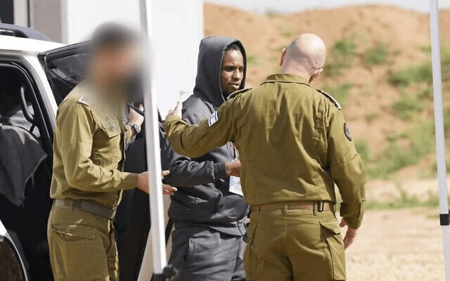 A released hostage is handed over to IDF troops.
