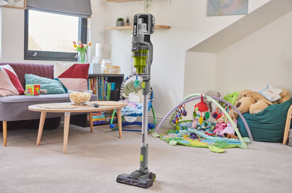 RYOBI cordless stick vacuum in a living room.