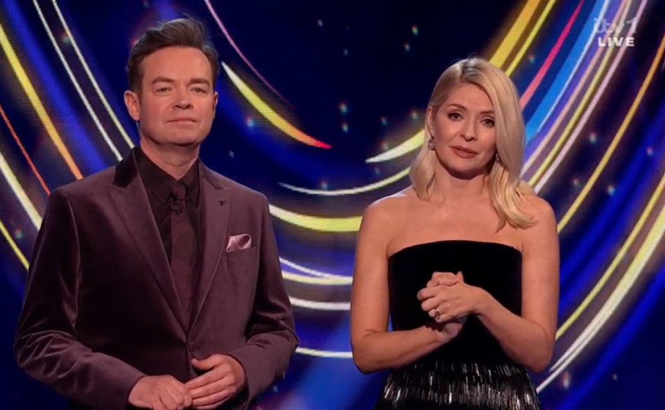 Two television presenters on stage.