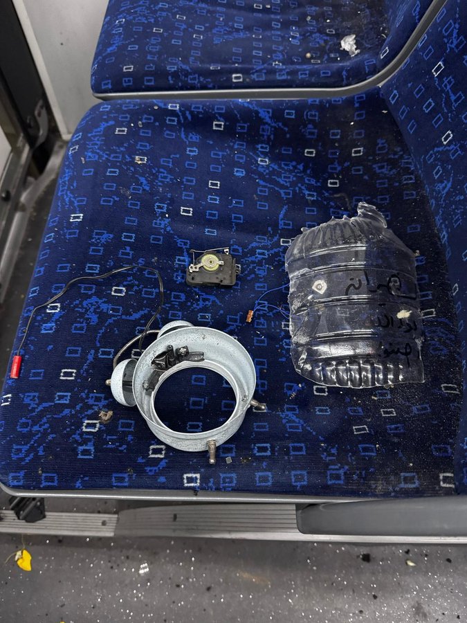 Disassembled clock parts and a plastic bag on a bus seat.