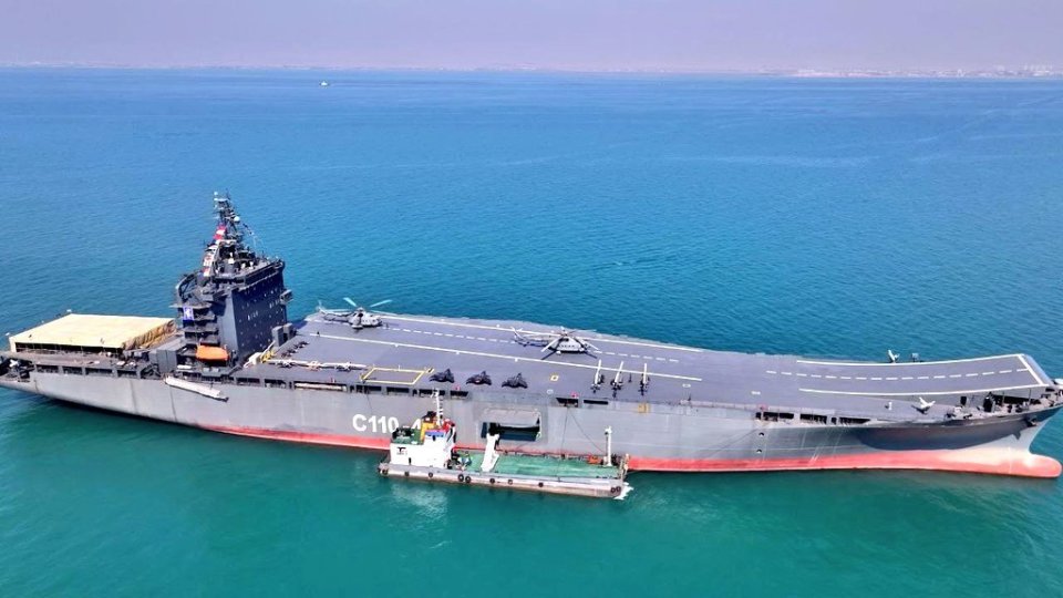 Aerial view of a large aircraft carrier at sea.