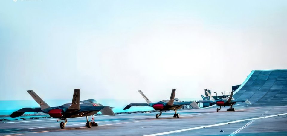 Three fighter jets on a runway.