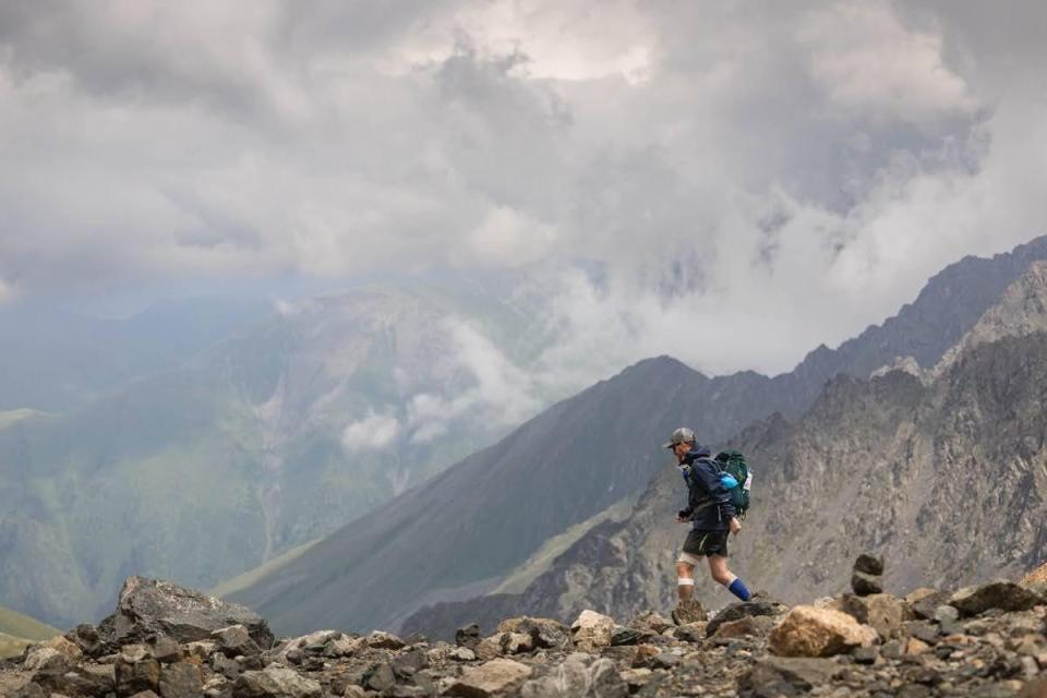 Hiker walking along a mountain ridge.