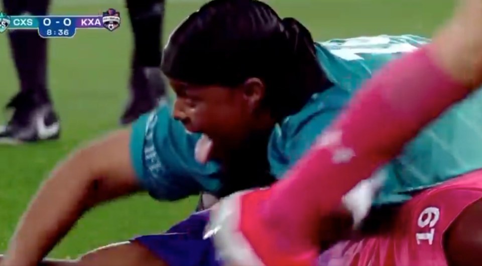 Soccer player on the ground being attended to.