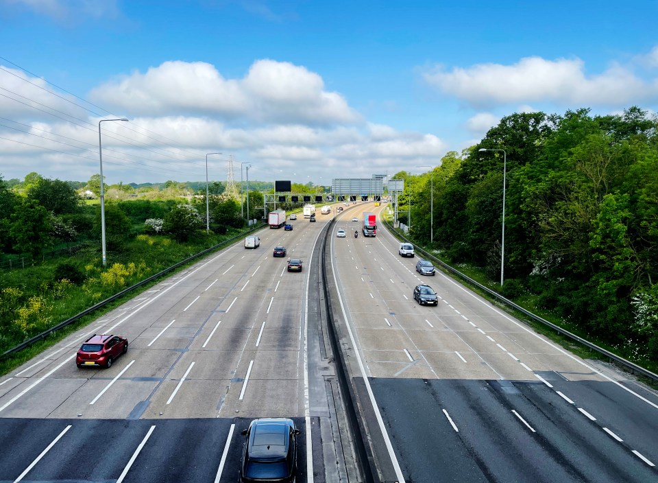 Cars driving on a multi-lane highway.