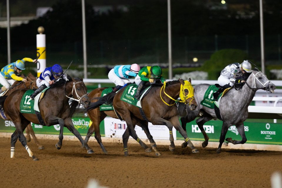 Jockeys racing horses in the Saudi Cup.
