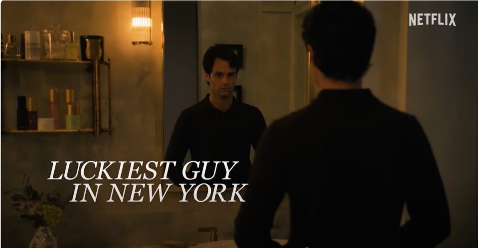 Screenshot from You season 5 showing Joe Goldberg looking in a mirror; text overlay reads "Luckiest Guy in New York".