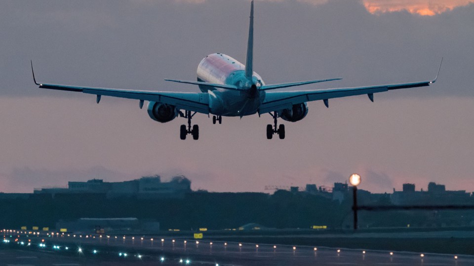 Airplane landing on a runway.