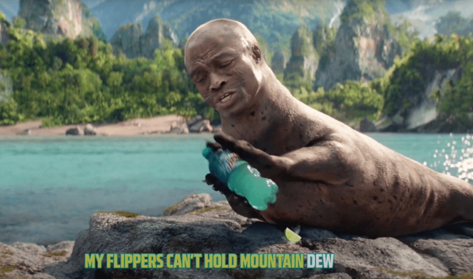A seal with a man's face struggles to hold a bottle of Mountain Dew.