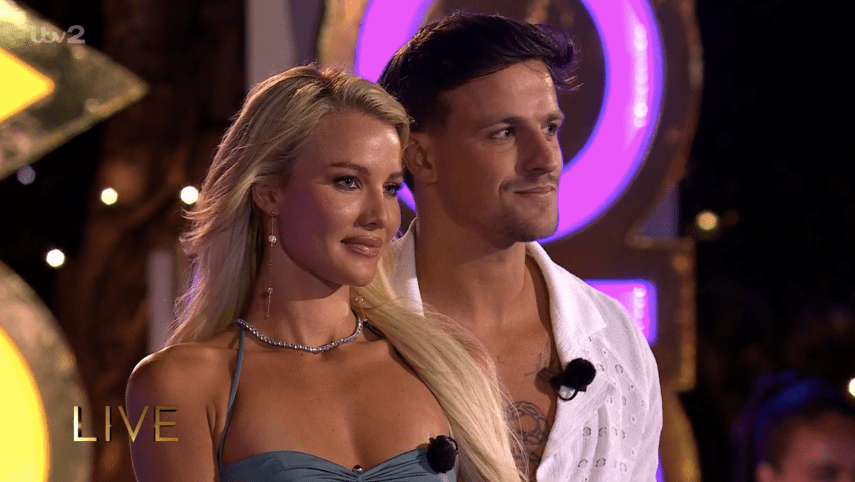 Screenshot of a man and woman standing together on a live TV show.