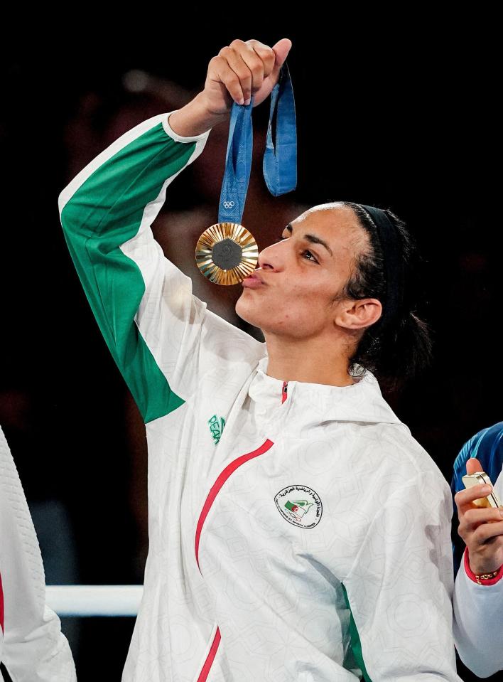 Algerian boxer Imane Khelif kisses her gold medal at the Paris 2024 Olympics.