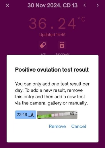 Positive ovulation test result displayed on a phone screen.