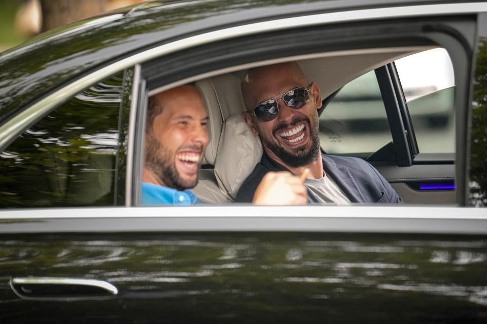 Andrew Tate and his brother Tristan laughing in a car.