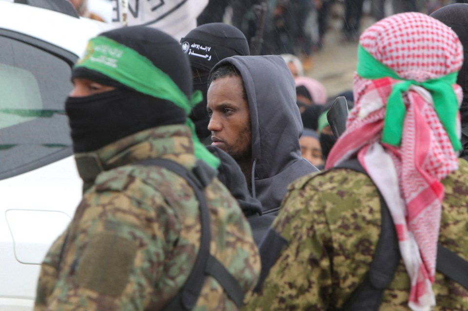 Avera Mengistu, escorted by Hamas militants, during a prisoner exchange.