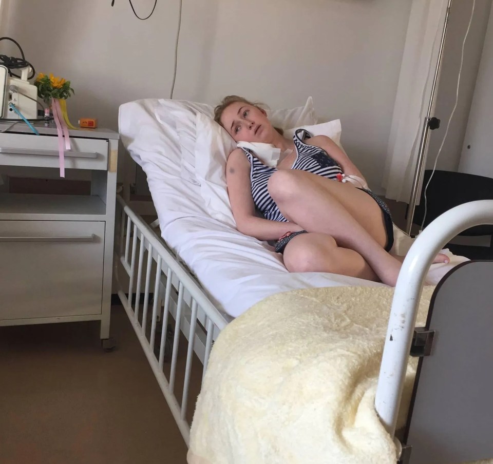 Woman lying in a hospital bed.