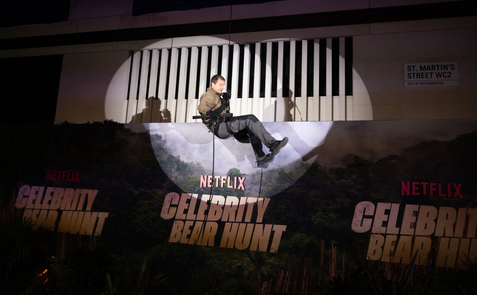 Bear Grylls rappelling down a building at the Celebrity Bear Hunt premiere.