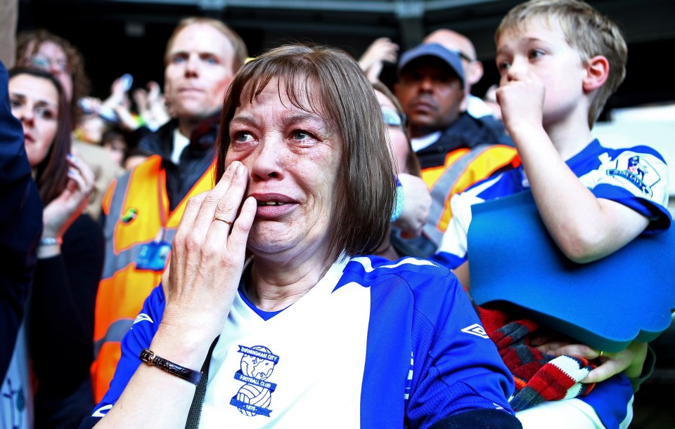 A dejected Birmingham City fan cries after her team's relegation.