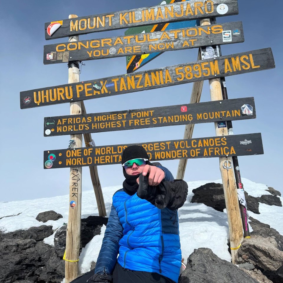 Person at the summit of Mount Kilimanjaro.