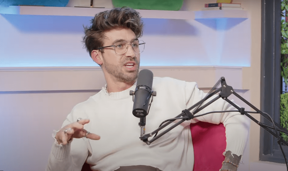 Man speaking into a microphone during a podcast.