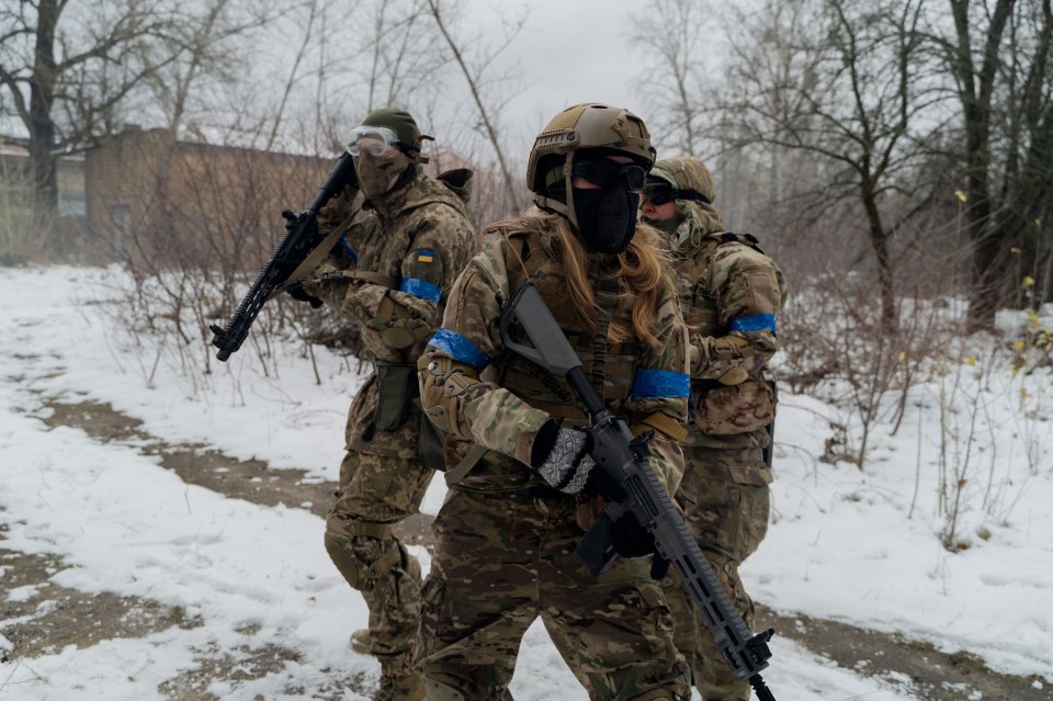 Civilians in military uniforms participate in military training.