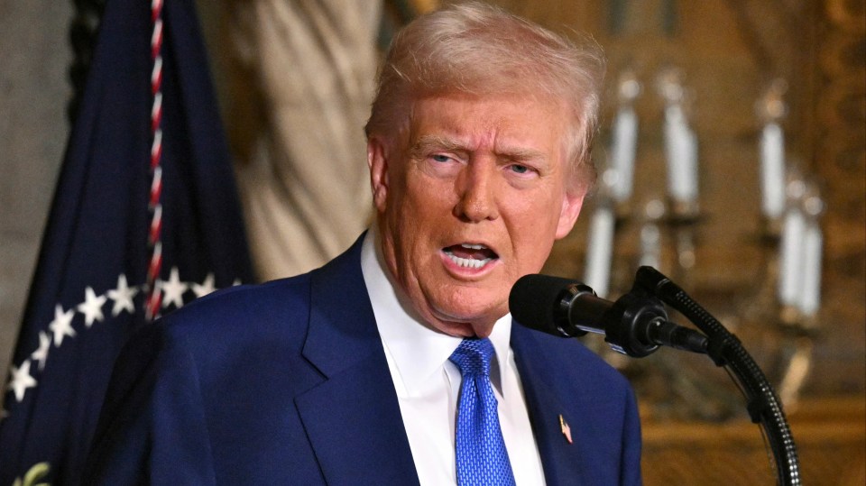 President Donald Trump speaking at a microphone.