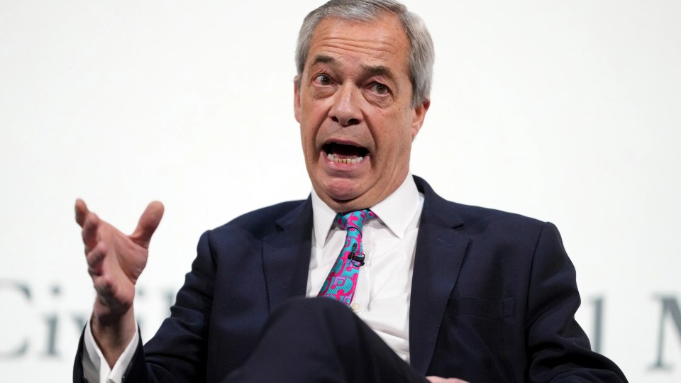 Nigel Farage speaking at a conference.