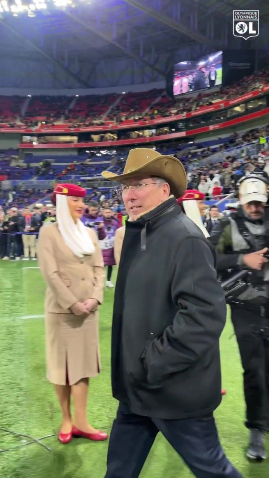 John Textor in a cowboy hat at a soccer stadium.
