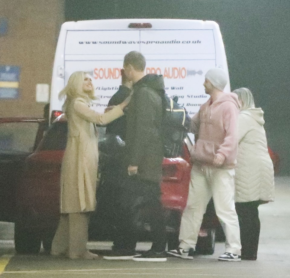 Dan Walker and Nadia Bychkova hugging in a car park.