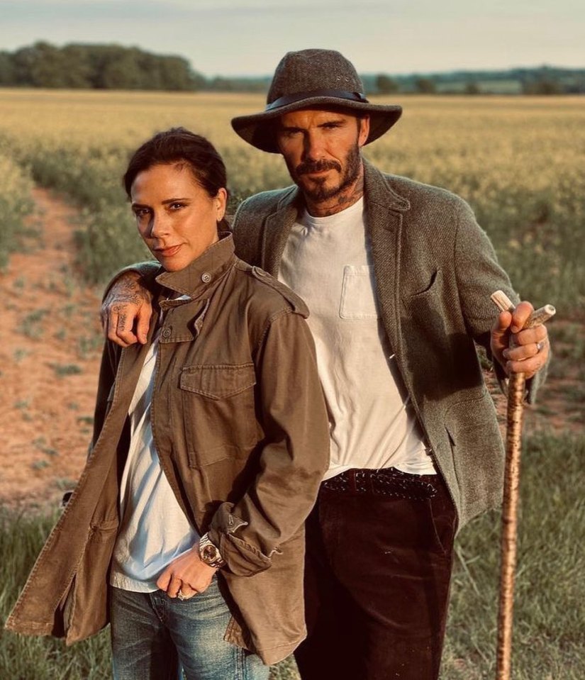 David and Victoria Beckham in a field.