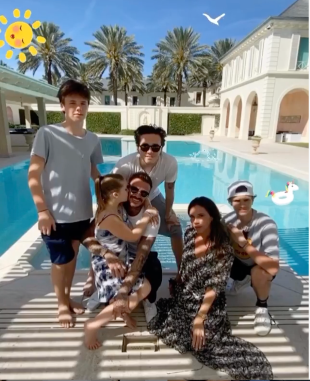 The Beckham family by a pool in Dubai.