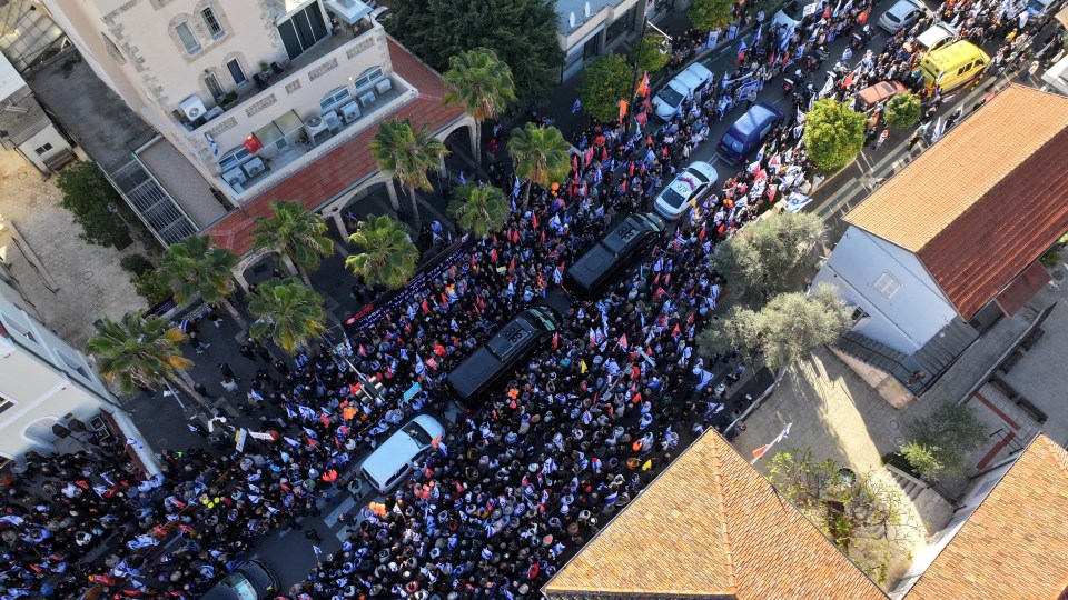 Aerial view of a large funeral procession in Rishon Le'Zion, Israel.
