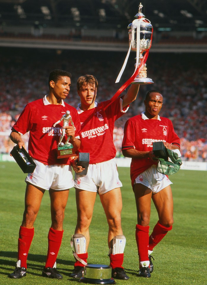 Nottingham Forest players with trophies after a football match.