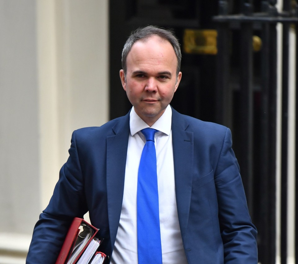 Gavin Barwell, former Member of Parliament, carrying files.
