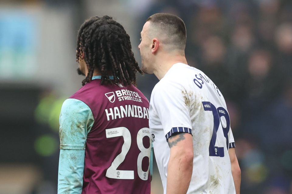Two soccer players facing each other on the field.