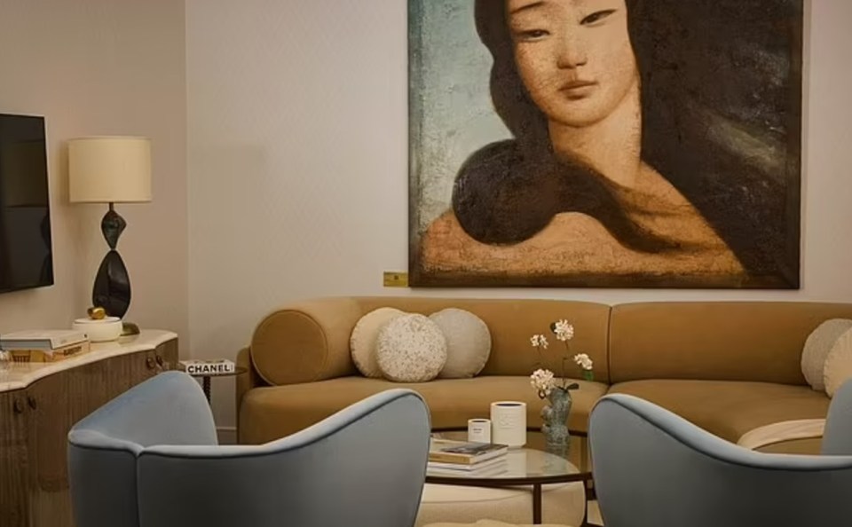 Upgraded private lounge area with curved sofa and artwork.