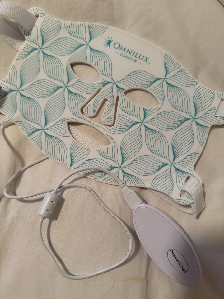 Omnilux Contour red light therapy mask with power cord and control.