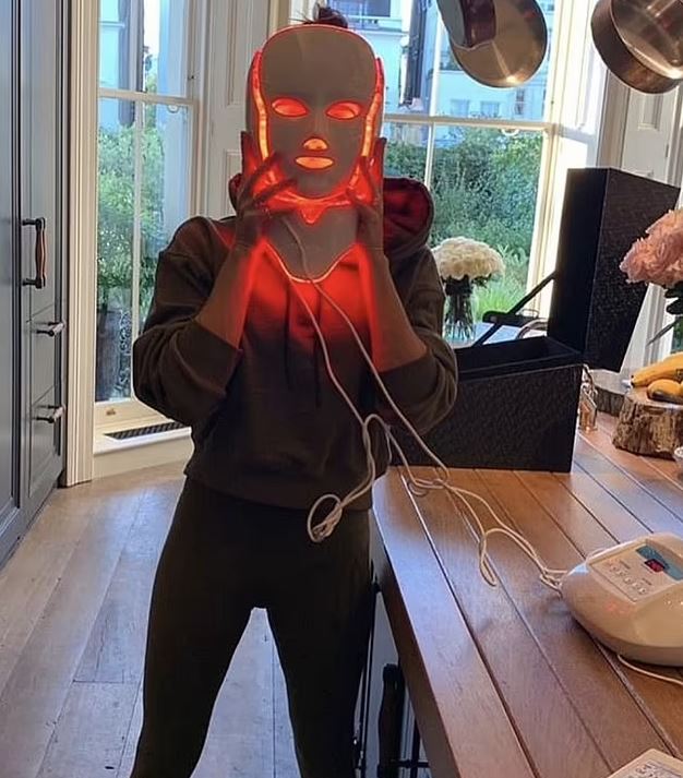 Person using a red light therapy face mask.