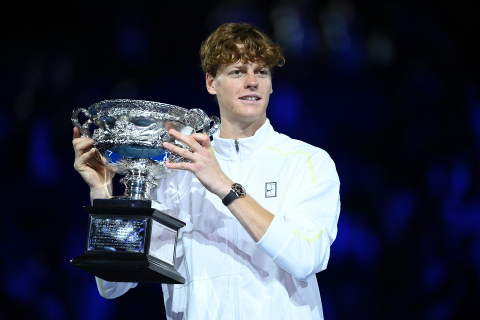 Jannik Sinner holding the Norman Brookes Challenge Cup after winning the Australian Open.